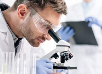 panoramic shot of molecular nutritionist using microscope in lab panoramic shot of molecular nutritionist using microscope in lab