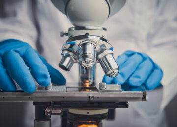 Close-up shot of microscope with metal lens at laboratory. Close-up shot of microscope with metal lens.